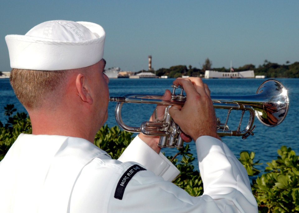 US Navy 051207-N-3019M-017 Musician 2nd Class Justin Belka, assigned to the Pacific Fleet Band, echoes taps during the 64th commemoration of the Dec. 7, 1941 attack on Pearl Harbor