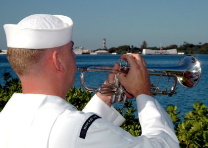 US Navy 051207-N-3019M-017 Musician 2nd Class Justin Belka, assigned to the Pacific Fleet Band, echoes taps during the 64th commemoration of the Dec. 7, 1941 attack on Pearl Harbor