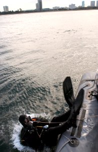 US Navy 051119-N-9851B-016 Chief Sonar Technician Isaac Callicrate, assigned to Explosive Ordnance Disposal Mobile Unit Five (EODMU-5), Detachment Japan, dives into Tokyo Bay to sweep the pier