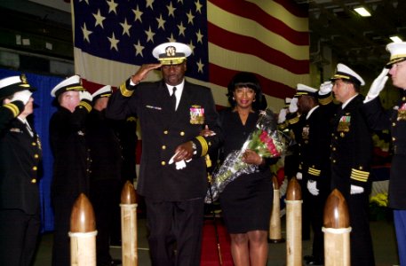 US Navy 051121-N-2736O-003 Rear Adm. Ruebin B. Bookert, accompanied by his wife renders his final salute to honorary side boys during his change of command ceremony held aboard the amphibious assualt ship USS Saipan (LHA 2)