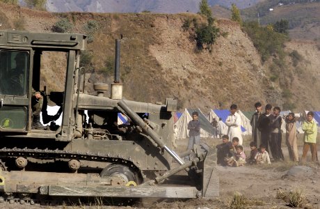 US Navy 051113-F-2729L-014 A U.S. Navy Seabee assigned to Naval Mobile Construction Battalion Seven Four (NMCB-74), levels the ground in Muzaffarabad, Pakistan photo