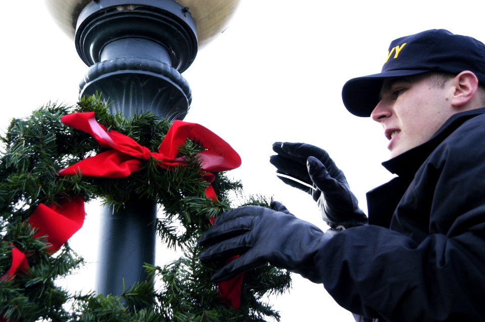 US Navy 051128-N-6477M-057 Information Systems Technician Seaman Patrick M. Rhodes assigned to the guided missile frigate USS Ingraham (FFG 61) helps to put up Christmas ornaments around Naval Station Everett