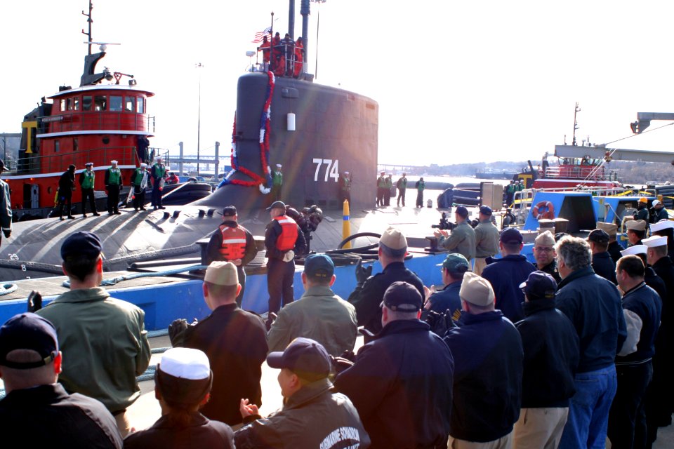 US Navy 051123-N-0653J-001 Friends and family members of Sailors assigned to the attack submarine USS Virginia (SSN 774), applaud as the submarine is moored to its pier