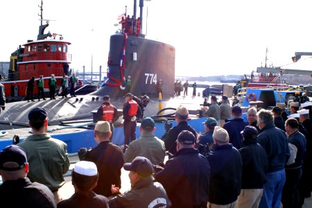 US Navy 051123-N-0653J-001 Friends and family members of Sailors assigned to the attack submarine USS Virginia (SSN 774), applaud as the submarine is moored to its pier photo