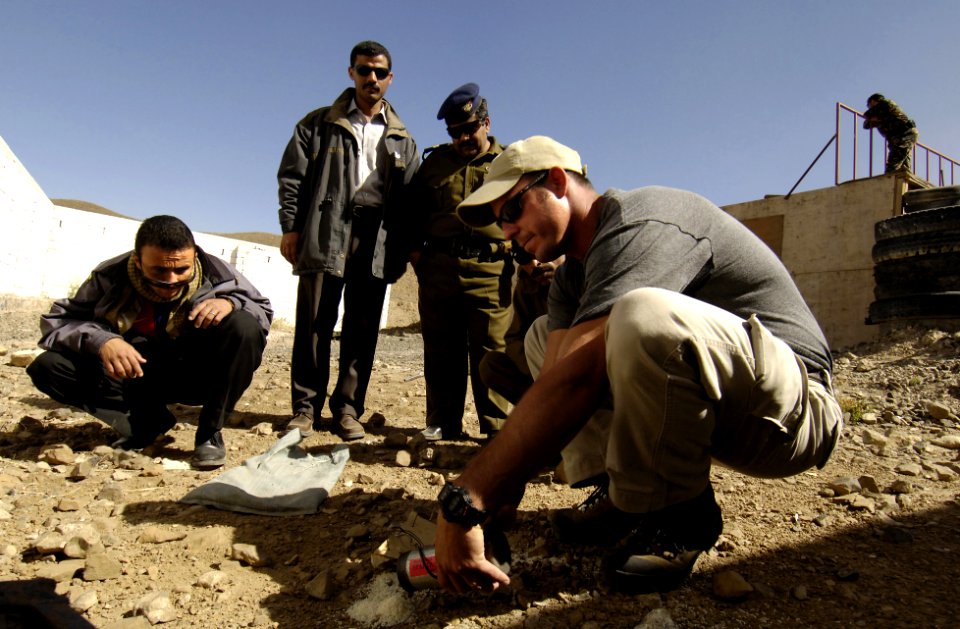 US Navy 051214-F-7234P-072 Chief Petty Officer Zach Holzhausen, shows Yemen Explosive Ordinance Disposal (EOD) team members the simulated Improvised Explosive Device (IED) after it was destroyed