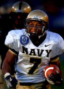 US Navy 051203-N-9769P-555 Navy slot back Reggie Campbell (7) of Sanford, Fla., breaks through the Army defense to open field during the 106th Army vs. Navy Football game held for the third consecutive year at Lincoln Financial