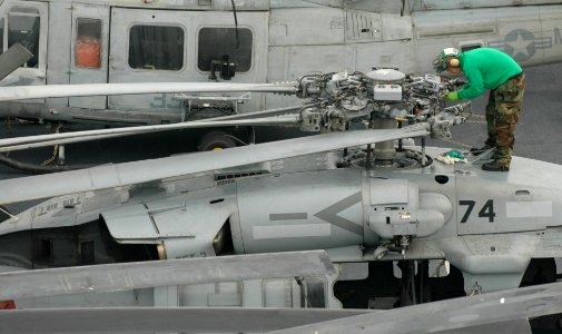 US Navy 051201-N-9866B-002 An Airman inspects the rotor head of a MH-60S Seahawk helicopter, assigned to Helicopter Sea Combat Squadron Two One (HSC-21)