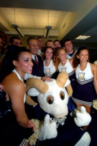 US Navy 051130-N-0295M-005 Secretary of Defense Donald Rumsfeld poses for a photograph with the U.S. Naval Academy cheerleader squad during a Pep-Rally