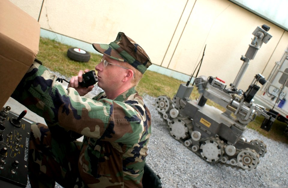 US Navy 051202-N-9851B-002 U.S. Navy Mineman 1st Class Kieth Pierson, assigned to Explosive Ordnance Disposal Mobile Unit Five (EODMU-5), Detachment Japan, directs the actions of a Remote Ordnance Neutralization System