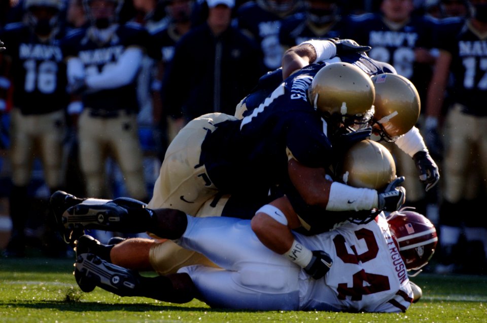 US Navy 051119-N-9693M-003 U.S. Naval Academy Midshipmen defenders pile onto Temple Owls running back Umar Ferguson (34) during the 1st quarter of play at Navy-Marine Corps Memorial Stadium
