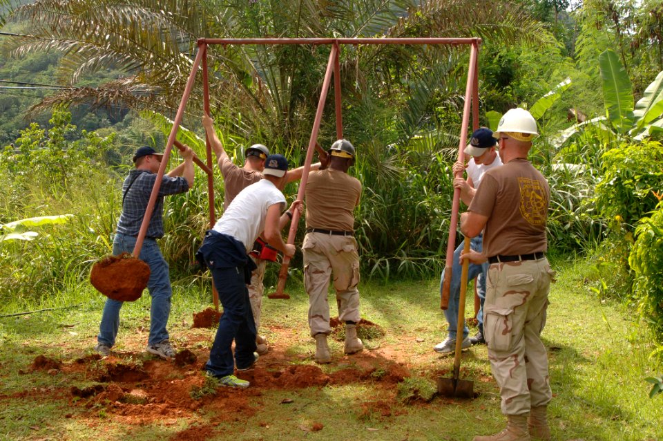 US Navy 051226-N-4374S-016 U.S. Navy Seabees assigned to Naval Mobile Construction Battalion Three (NMCB-3) and Sailors assigned to USS Winston S. Churchill (DDG 81) remove an old swing set
