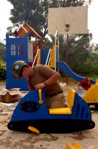 US Navy 051226-N-4374S-020 Builder DeLacy Gant, a U.S. Navy Seabee assigned to Naval Mobile Construction Battalion Three (NMCB-3), assembles a Speedy Speedway cart