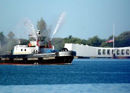 US Navy 051207-N-3019M-018 A tugboat performs a water tribute during the 64th commemoration of the Dec. 7, 1941 attack on Pearl Harbor, Hawaii photo