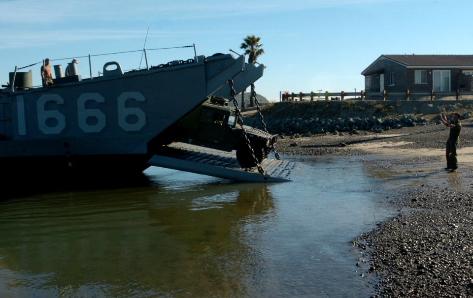 US Navy 051205-N-9866B-033 A U.S. Marine directs a humvee out of Landing Craft, Utility One Six Six Six (LCU-1666) assigned to Amphibious Craft Unit One (ACU-1)