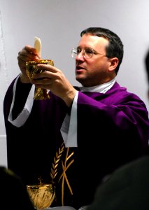 US Navy 051211-N-7730P-020 U.S. Navy Chaplain, Lt. Kenneth Medve, performs Catholic services for the crew aboard the Nimitz-class aircraft carrier USS Ronald Reagan (CVN 76)