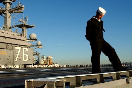 US Navy 060104-N-4776G-043 Airman Eric Enriquez from El Paso, Texas thinks about his family and friends as he prepares to man the rails and get underway aboard USS Ronald Reagan (CVN 76)