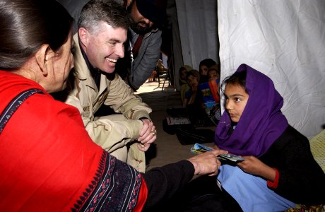 US Navy 060105-F-2729L-006 U.S. Navy Kenneth Braithwaite, assigned to the Disaster Assistance Center Pakistan, visits children at Narul Girls High School in Muzaffarabad, Pakistan photo