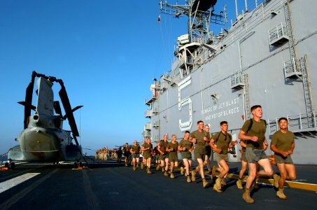 US Navy 051112-N-9866B-034 U.S. Marines assigned to the 11th Marine Expeditionary Unit perform physical training on the flight deck of the amphibious assault ship USS Peleliu (LHA 5)