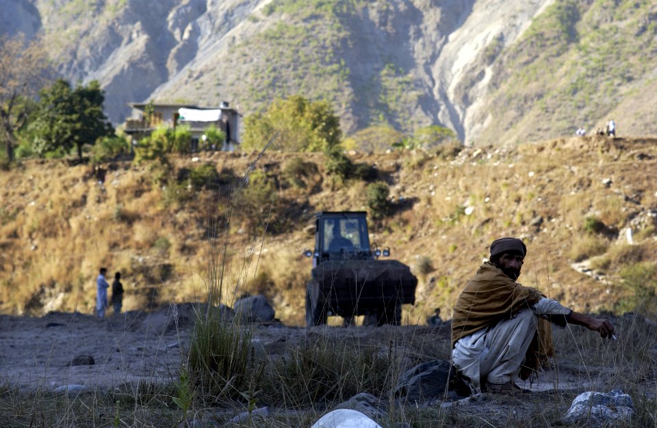 US Navy 051113-F-2729L-017 A U.S. Navy Seabee assigned to Naval Mobile Construction Battalion Seven Four (NMCB-74), levels the ground in Muzaffarabad, Pakistan
