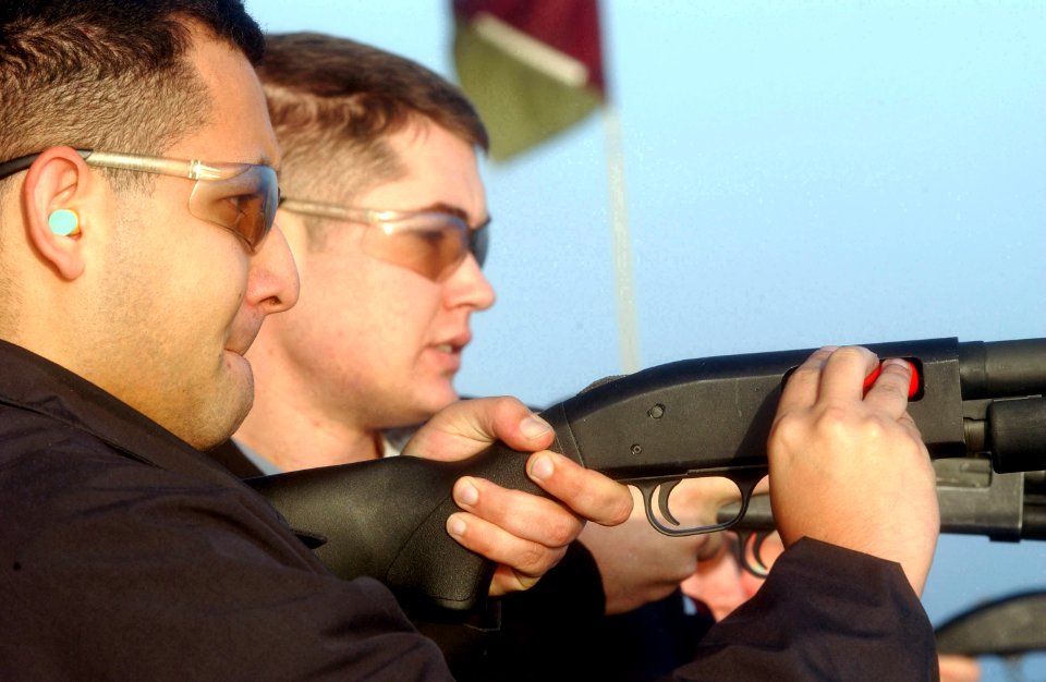 US Navy 060109-N-0361G-027 Aviation Ordnanceman 3rd Class James Tipton of Pasadena, Calif., loads a shotgun during a live fire exercise