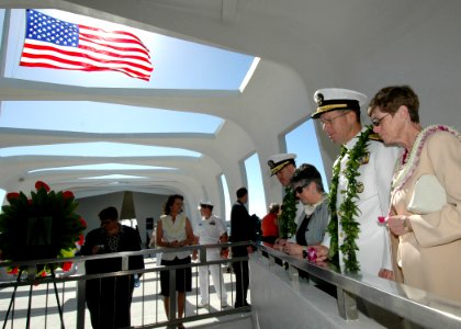 US Navy 051207-N-3019M-019 Chief of Naval Operations Adm. Mike Mullen prepares to toss a flower into the well aboard the USS Arizona Memorial