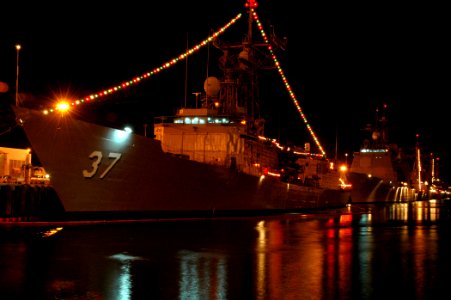 US Navy 051209-N-3019M-001 Strings of multi-colored lights illuminate the guided missile frigate USS Crommelin (FFG 37)