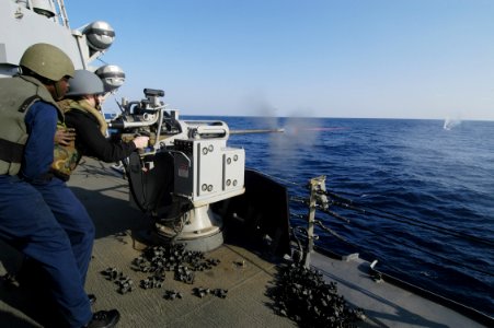 US Navy 060112-N-2385R-194 A Sailor fires a MK-38 25mm machine gun at a killer tomato, during a live fire exercise