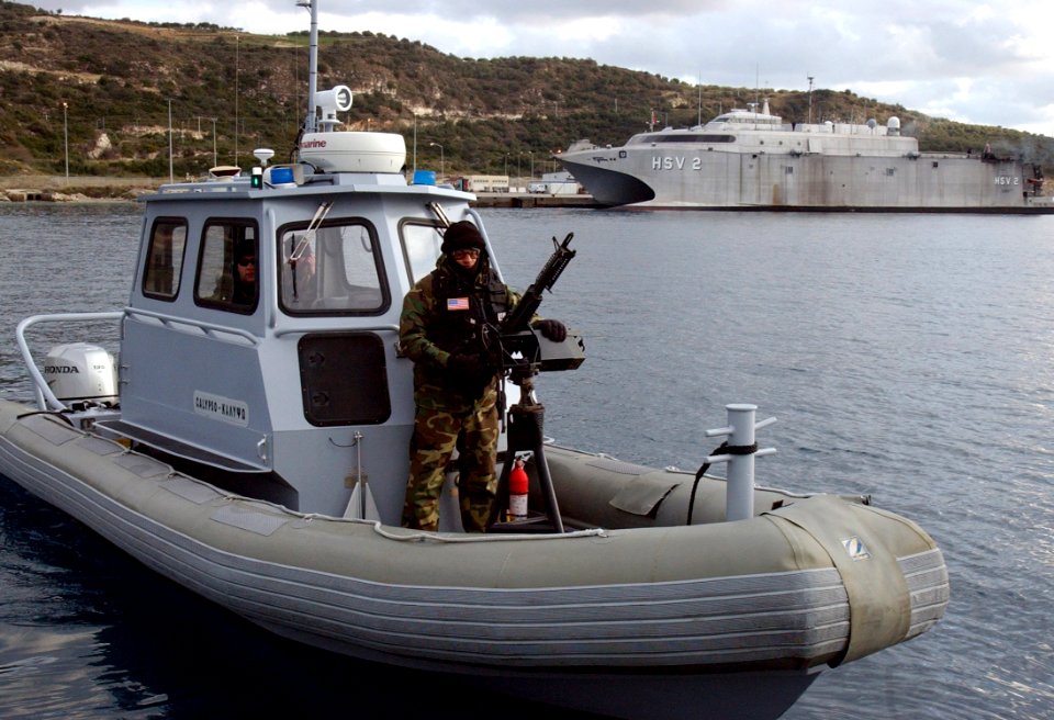 US Navy 060112-N-0780F-006 A Sailor assigned to a harbor patrol unit at the U.S. Naval Support Activity Souda Bay's Security Department mans an M60 7.62 caliber machine gun