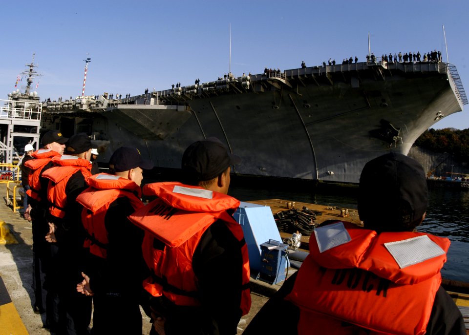 US Navy 051212-N-2385R-009 Sailors assigned to Commander, Fleet Activities Yokosuka Port Operations, stand by as the conventionally powered aircraft carrier USS Kitty Hawk (CV 63) arrives