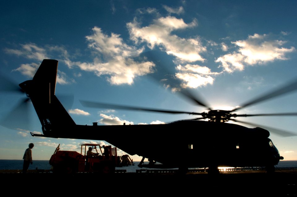 US Navy 051203-N-9866B-044 Combat Cargo Marines assigned to the 11th Marine Expeditionary Unit load equipment on a CH-53 Super Stallion helicopter on the flight deck of the amphibious assault ship USS Peleliu (LHA 5)