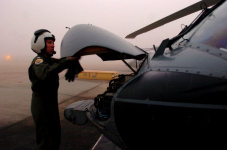 US Navy 060113-N-9866B-004 Lt. Jessica Parker, a MH-60S Seahawk helicopter pilot, assigned the Black Jacks of Helicopter Sea Combat Squadron Two One (HSC-21), conducts a pre-flight check