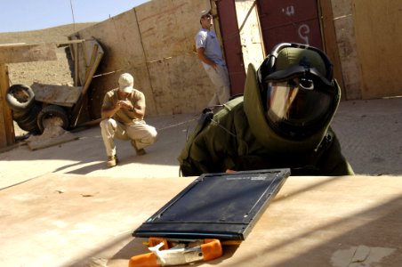US Navy 051218-F-7234P-066 U.S. Navy Petty Officer 2nd Class Dennis Ballais and Chief Petty Officer Zach Holzhausen watch Waleed Humayan Ahmed, a Yemen Explosive Ordinance Disposal (EOD) team member, place an x-ray machine near