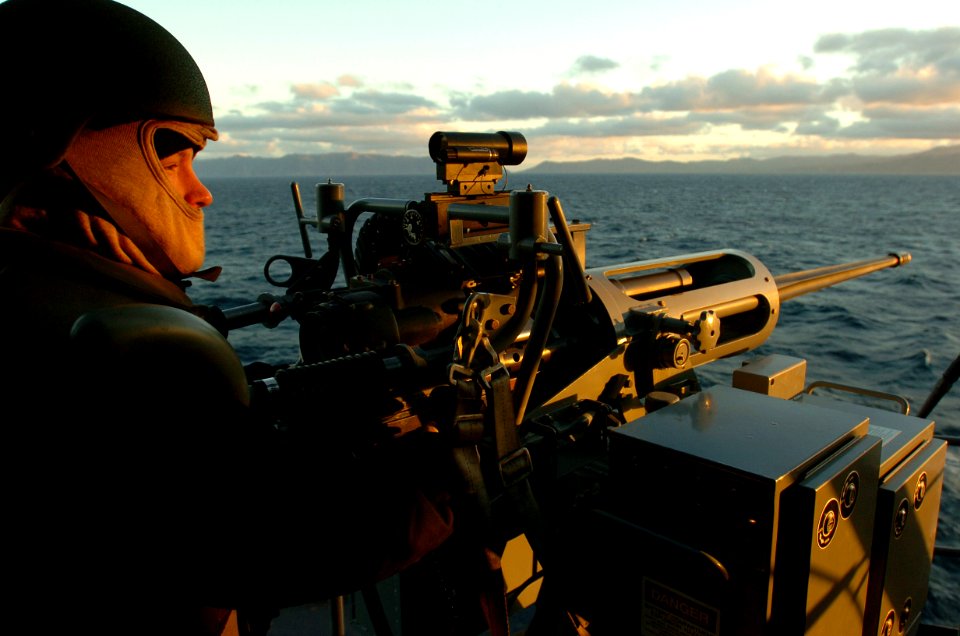 US Navy 060115-N-9866B-003 Aviation Ordnanceman 3rd Class John Hicks mans a MK-38 25mm machine gun