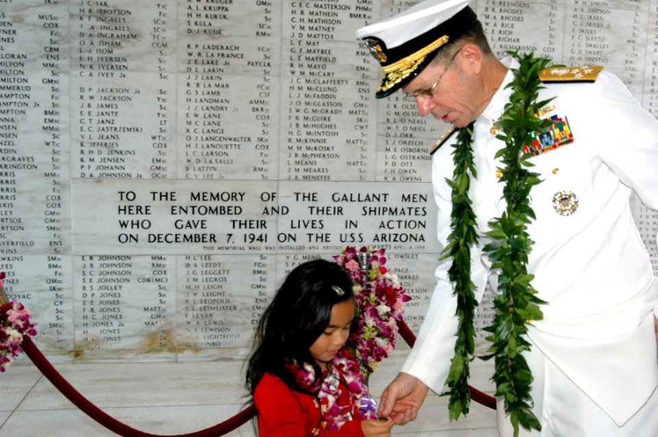 US Navy 051207-N-3019M-020 Chief of Naval Operations Adm. Mike Mullen hands his official coin to a Hawaiian girl aboard the USS Arizona Memorial
