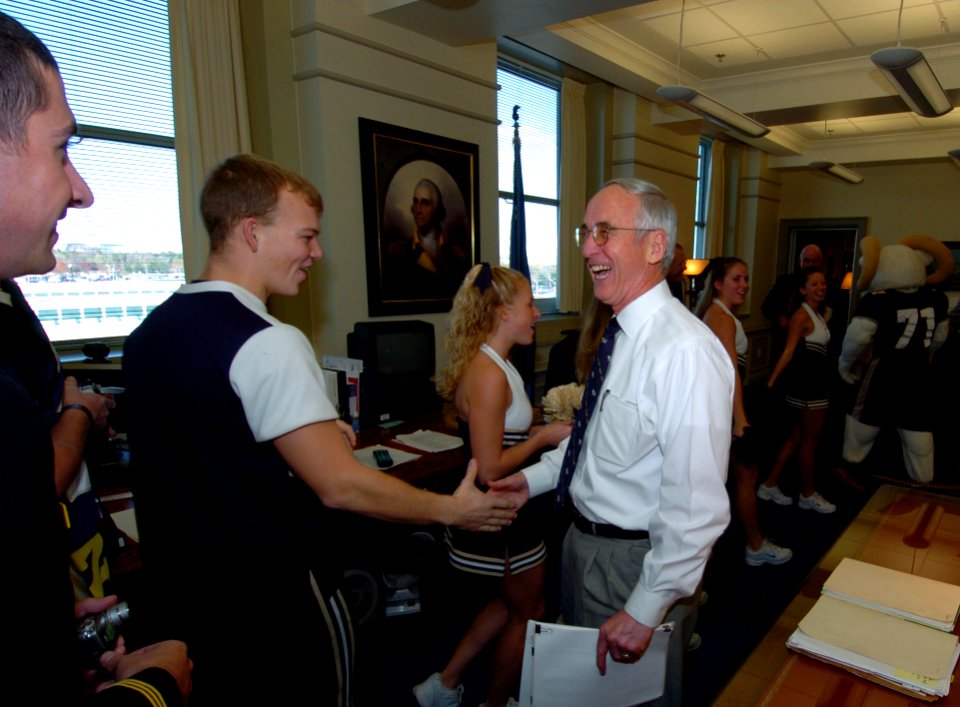 US Navy 051130-N-0295M-002 Deputy Secretary of Defense Gordon England shakes the hands of U.S. Naval Academy cheerleaders during a Pep-Rally at the Pentagon