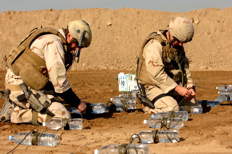 US Navy 060105-A-3283V-012 U.S. Navy Lt. Robert Marsh and Boatswain's Mate 1st Class Bill Davison prepare for a test detonation at a range in Ad Diwaniyah, Iraq