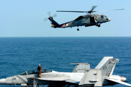 US Navy 051202-N-3488C-059 A plane captain assigned to the Diamondbacks of Strike Fighter Squadron One Zero Two (VFA-102), hand wipes a canopy of one of his squadron's F-A-18F Super Hornets