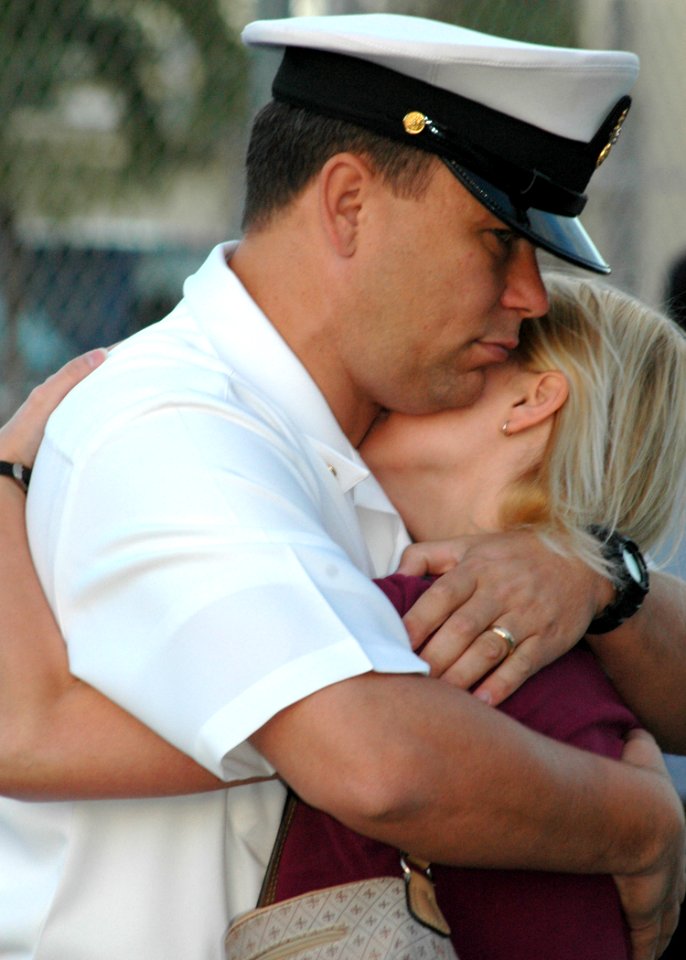 US Navy 060105-N-3019M-001 Chief Cryptological Technician Will Rodgers hugs his wife on the pier before departing aboard the guided missile destroyer USS Chung-Hoon (DDG 93)