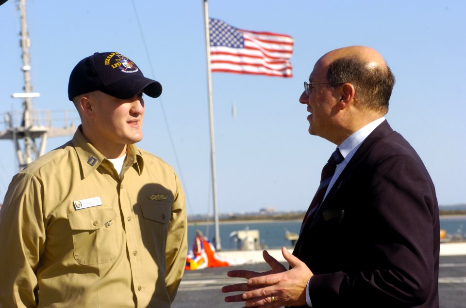 US Navy 060113-N-2568S-122 Lt. Paul Allgeier, operations officer aboard the amphibious transport dock ship USS San Antonio (LPD 17), explains typical flight deck operations to Secretary of the Navy Dr. Donald C. Winter