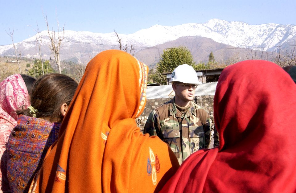 US Navy 060105-F-2729L-002 U.S. Navy Lt. Michael Trest assigned to Naval Mobile Construction Battalion Four (NMCB-4) talks to Pakistani children at Miani Bandi