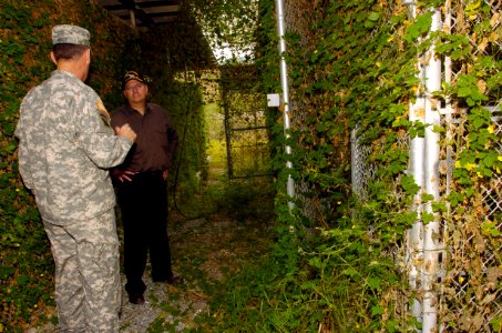US Navy 060108-N-2568S-047 Led by Joint Task Force Guantanamo Commanding General, Maj. Gen. Jay Hood, Secretary of the Navy (SECNAV), Dr. Donald C. Winter, inspects the heavily overgrown remains of Camp X-ray