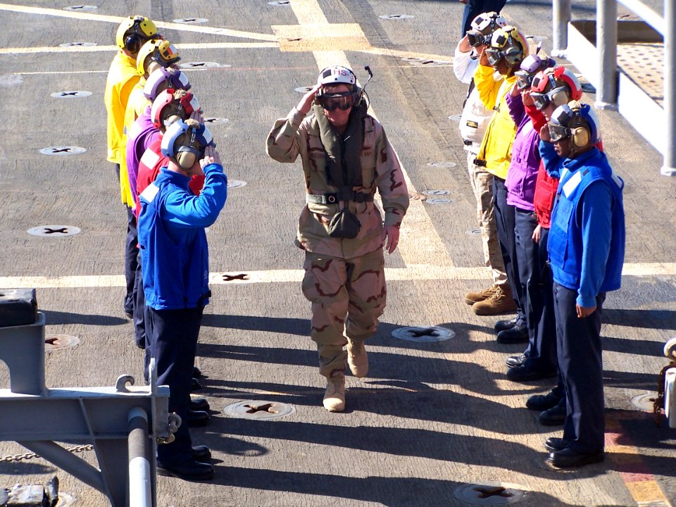 US Navy 060109-N-0000X-001 Chief of Naval Operations, Adm. Mike Mullen salutes as he passes the rainbow sideboys aboard the amphibious transport dock ship USS Austin (LPD 4)