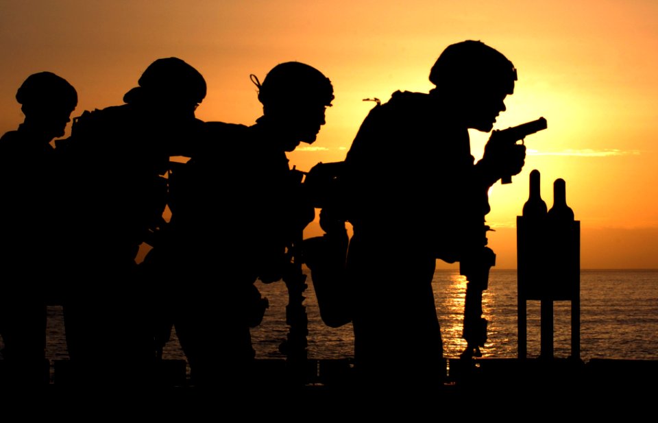US Navy 060114-N-9866B-002 Marines assigned to the 11th Marine Expeditionary Unit (MEU) fire 9mm handguns on the flight deck of the amphibious assault ship USS Peleliu (LHA 5)