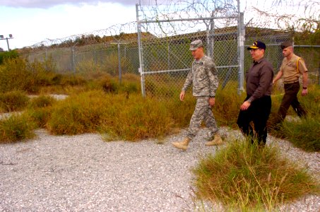 US Navy 060108-N-2568S-055 Led by Joint Task Force Guantanamo Commanding General Maj. Gen. Jay Hood, Secretary of the Navy (SECNAV), Dr. Donald C. Winter, inspects the heavily overgrown remains of Camp X-ray