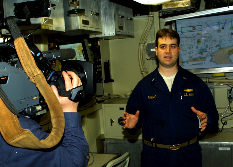 US Navy 060129-N-1464F-025 Lt. j.g. Aaron Riggio (right) explains the new Battle Management Center (BMC) and how it will provide true joint integration aboard the guided missile submarine USS Ohio (SSGN 726)