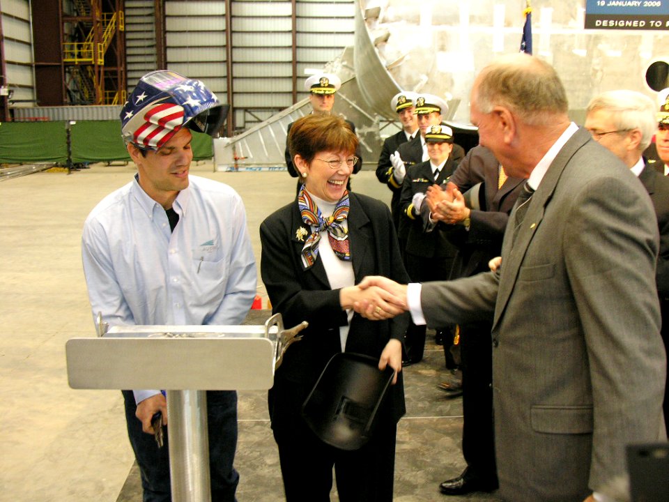 US Navy 060119-N-0000X-001 The Assistant Secretary of the Navy for Research, Development and Acquisition, the Honorable Delores Etter, center, shakes hands with Executive Chairman of Austal Ltd., Mr. John Rothwell