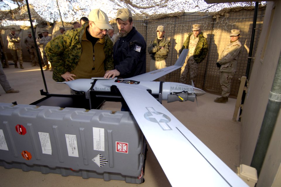 US Navy 060129-N-2568S-098 Darrin Wagoner explains to Secretary of the Navy (SECNAV), the Honorable Dr. Donald C. Winter, the operation and capabilities of the Unmanned Aerial Vehicle (UAV) Scan Eagle