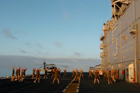 US Navy 060114-N-9866B-017 Marines assigned to the 11th Marine Expeditionary Unit (MEU) perform jumping jacks on the flight deck of the amphibious assault ship USS Peleliu (LHA 5)
