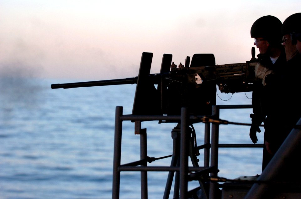 US Navy 060117-N-9866B-363 Aviation Ordnanceman 3rd Class Carlos Pizana fires a 50 cal. machine gun during a familiarization fire