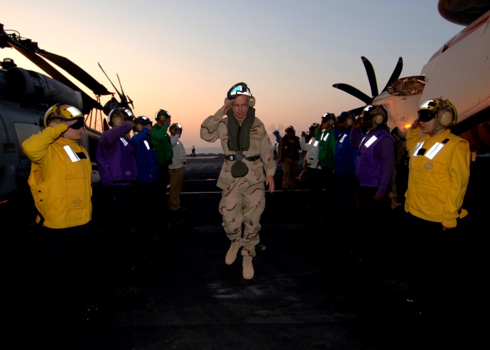 US Navy 060104-N-2838C-001 Chief of Naval Operations (CNO) Admiral Mike Mullen walks through sideboys as honors are rendered. Admiral Mullen is aboard USS Theodore Roosevelt (CVN 71) for an overnight visit